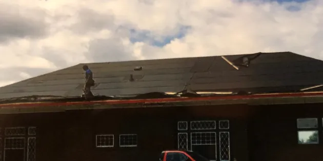 During: roofer installing the new roof on the museum